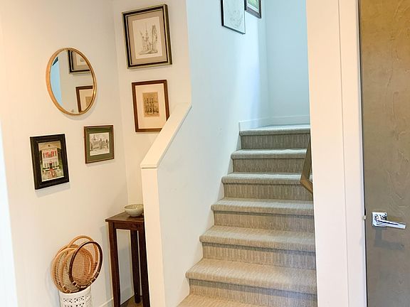 Entryway is bright and has a deep closet. Built-in coat hooks are next to the internal doorway to the garage (not pictured).