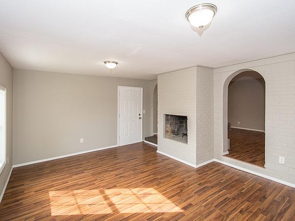 Huge family room with arched door ways and see through firep