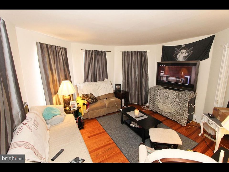 Sun-filled living room with 4 windows providing abundant natural light