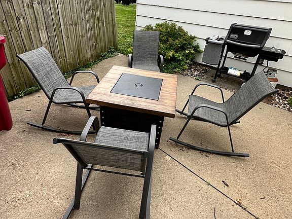 Fire-pit and gas grill for use of building residents. In screened patio area