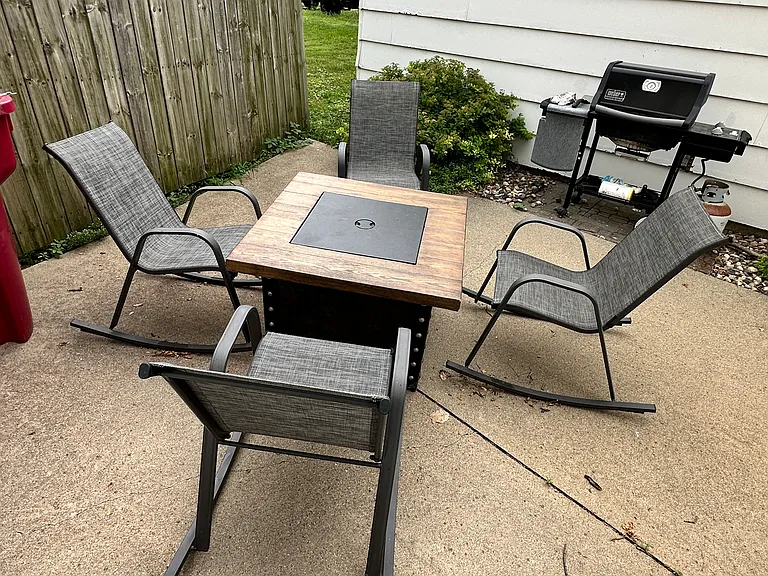 Fire-pit and gas grill for use of building residents. In screened patio area