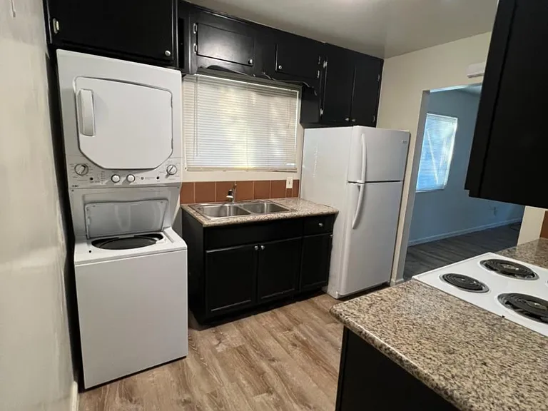 Kitchen with washer, dryer and refrigerator