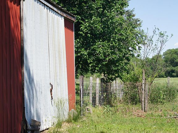Barn is next to a small orchard