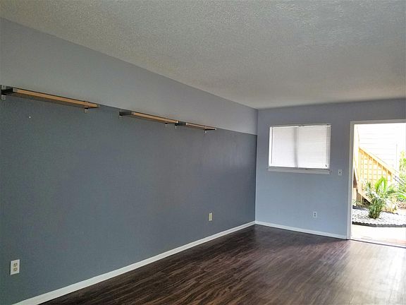 view of living room from sliders--front door (no longer has shelves and the wall is all one color--grey)