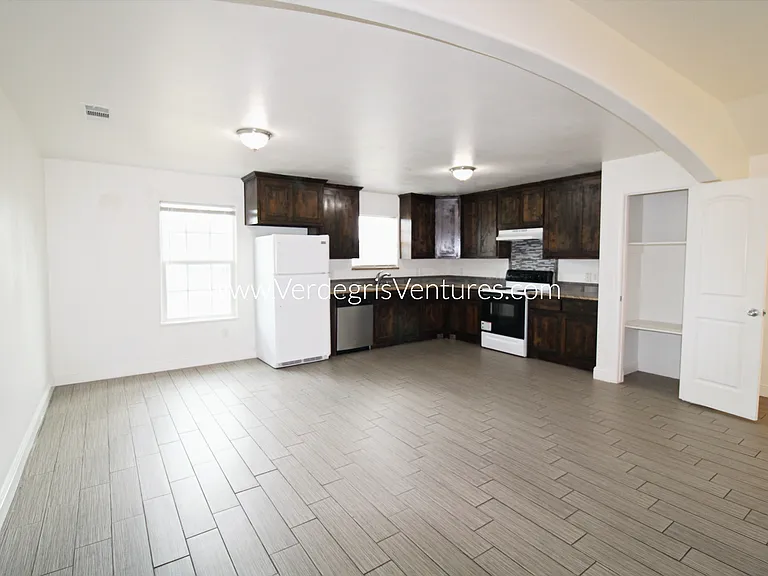 A spacious, open_concept layout connecting the kitchen, living, and dining areas.