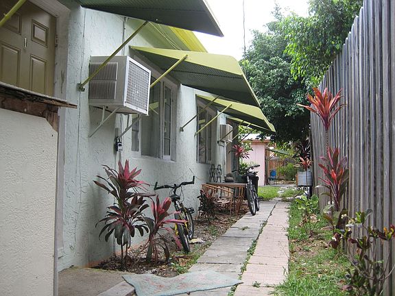 North side of property looking toward back (free standing, pink 1/1 unit)