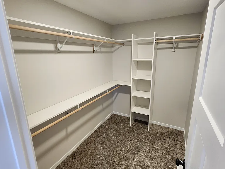 Primary bedroom closet. (Pictures are of another unit with similar finishes and features.)