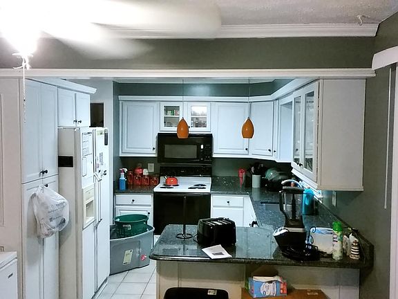 Townhouse - Main Floor Kitchen with two access points to the dining room and a sliding glass door leading out on to upper deck and sweeping views of Lake Churchill
