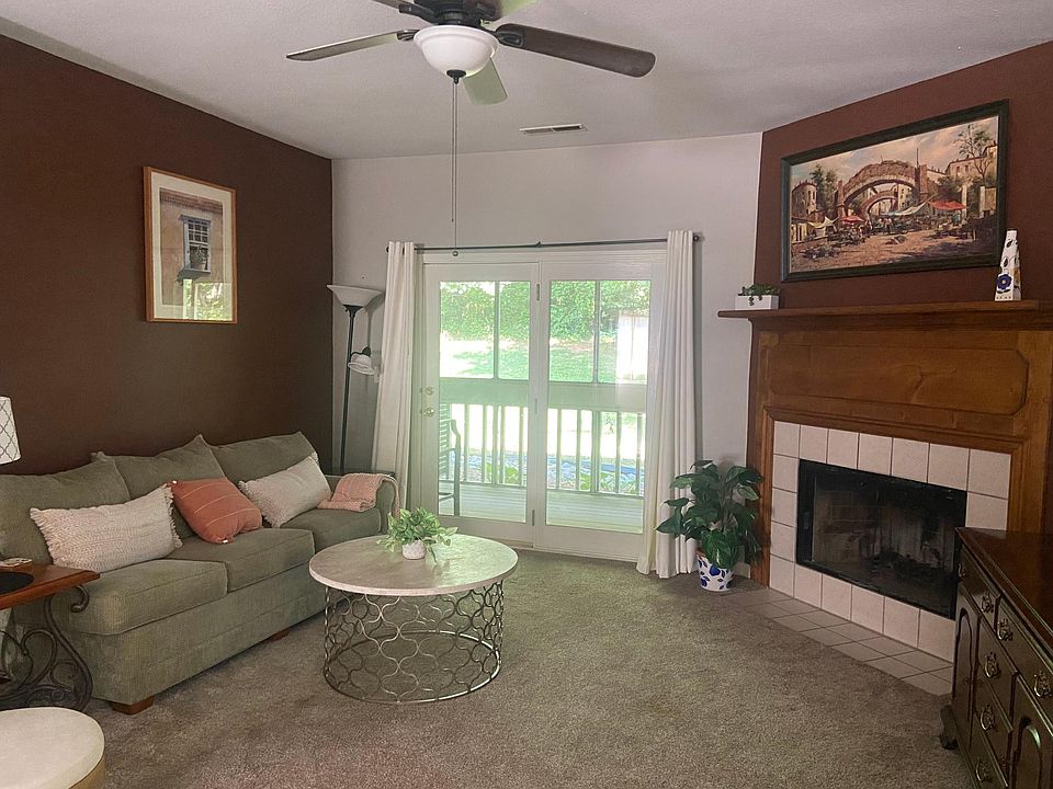 Living room with porch and wood burning fireplace