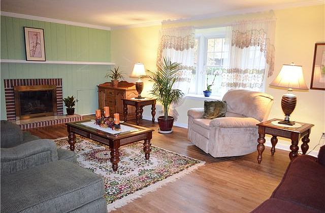 Living room has hardwoods and bow window