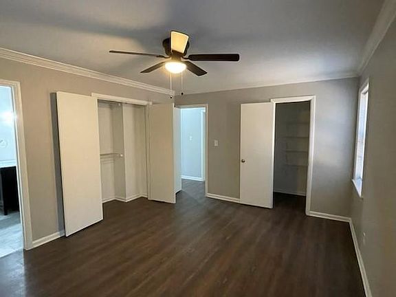 master bedroom facing closets and door