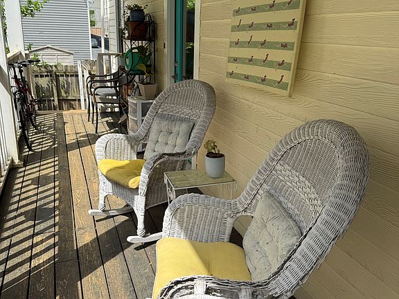 The downstairs porch runs alongside the house.