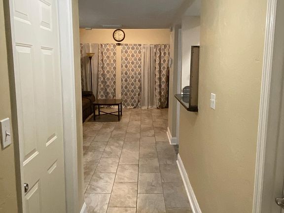 Entry Way from Bedroom to living room (front door on left, bathroom door on right)