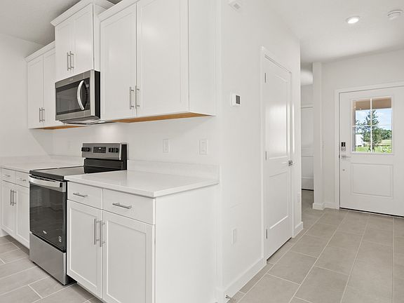 View of the interior entry and the kitchen in the Flagler by DRB Homes in Hamilton Bluff