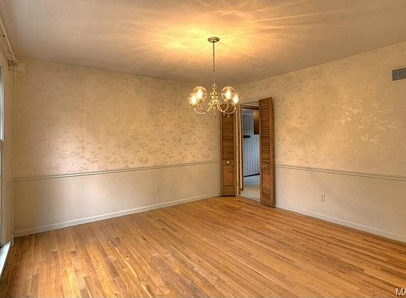 The formal dining room features a charming chair rail and five a