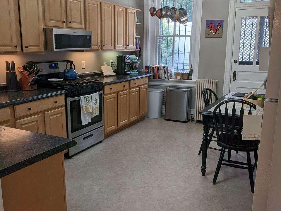 Kitchen includes dishwasher, gas stove, microwave and stackable full-sized washer/dryer. Also exit to covered balcony.