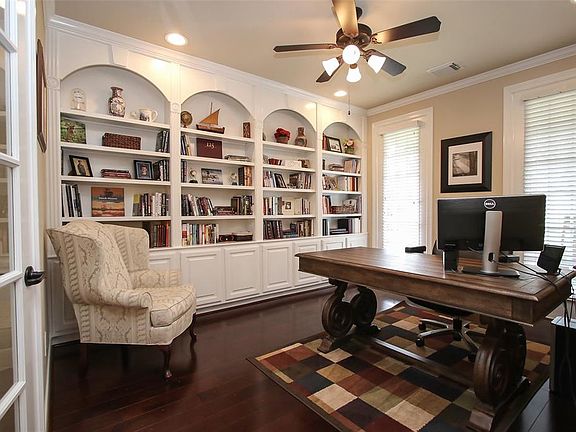 The study downstairs has French doors, beautiful built in cabinets and wood floors.