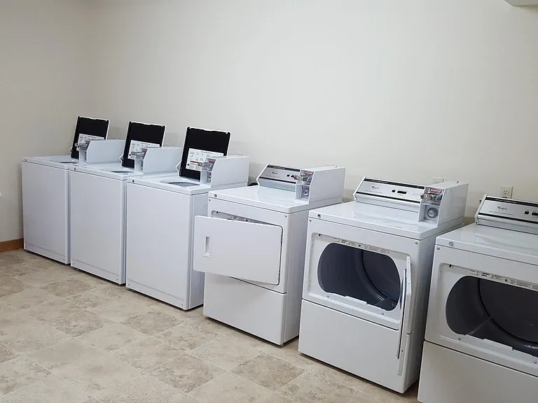 Coin-operated laundry in building (same level)