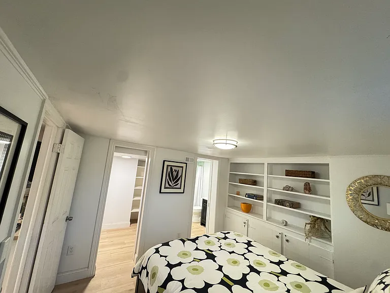The bedroom connects to the bathroom (right door) and the walk-in closet (left door)