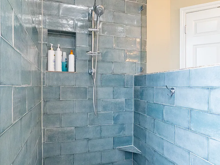 Spacious bathroom attached to the primary bedroom with double sinks, large mirror, and ample counter space. Convenient access to the walk-in closet. Bright, clean, and easy to get ready in.