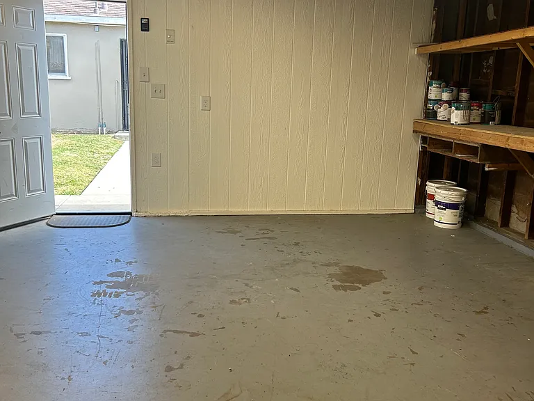 View from inside the garage to the pathway back to the home back door