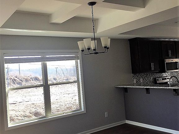 Dining room with hardwood floors, and coffered ceiling