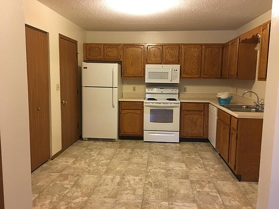 Kitchen area with small dining table area . MW / DW / pantry left of refrigerator / hot water cupbd left