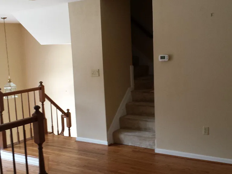 living room to stairs down to front door and upstairs to bedrooms