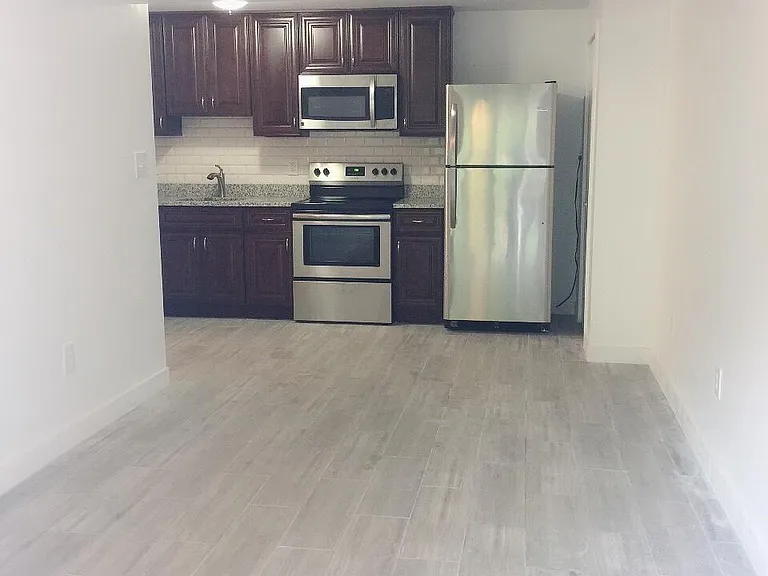 Light filled living room with kitchen