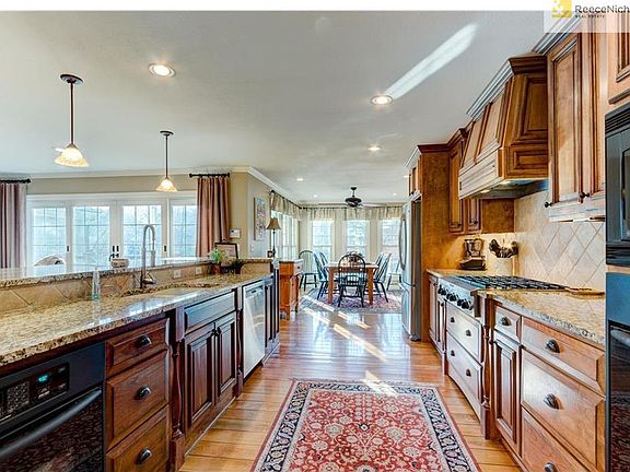 Acres of granite, custom cabinetry, a divine dining alcove.