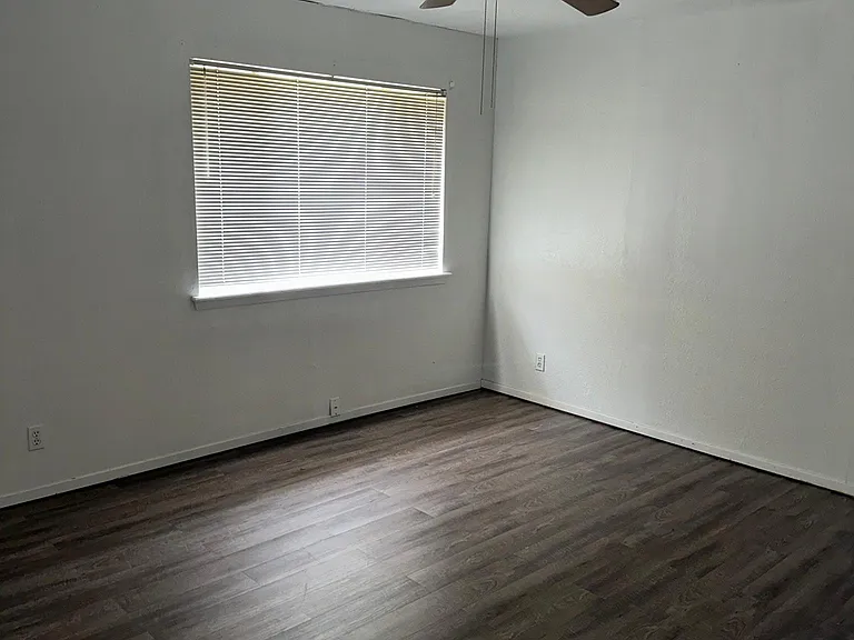 Bedroom 1, the bigger bedroom with two closets and ceiling fan