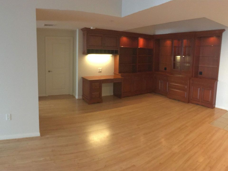 Dining area with built-in shelving, storage cabinets, and desk.
