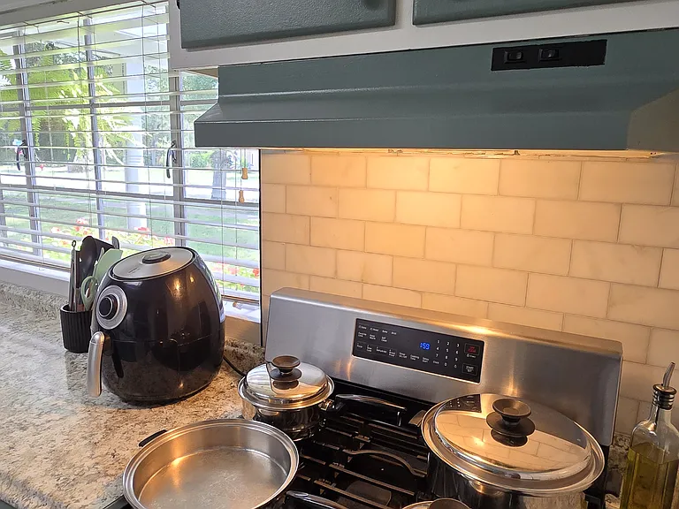 kitchen w/ air fryer, toaster, microwave, stove, fridge, dishwasher, coffee maker