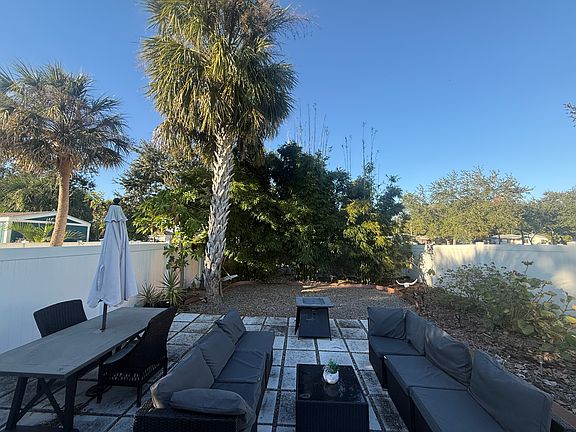 Low maintenance garden with mature bamboo and seating area.