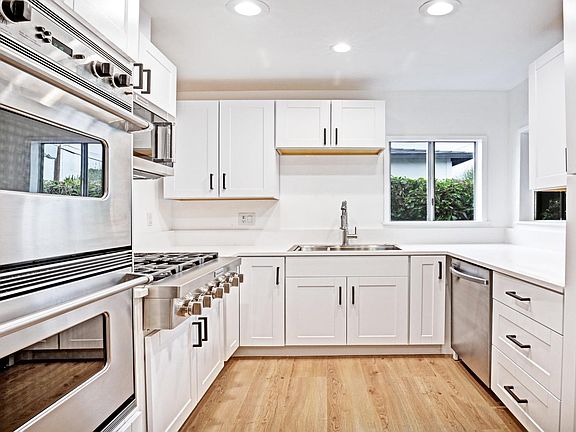 Bright remodeled kitchen with all appliances included: 6-burner Viking stove, separate double, dishwasher and microwave with plenty of storage.