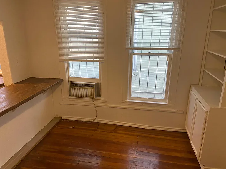 Living room next to kitchen with built in cabinets adjoining kitchen and tv room