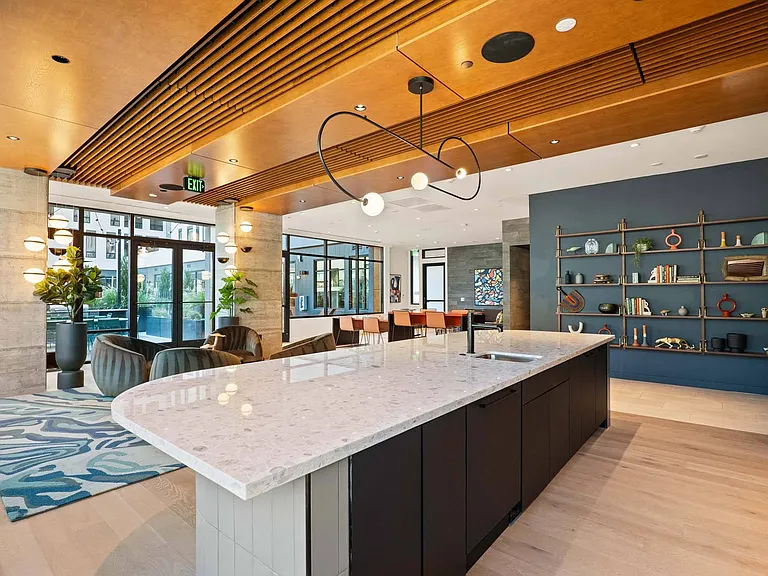 Impress in a huge lounge with a stunning kitchen island featuring a sleek marble countertop.