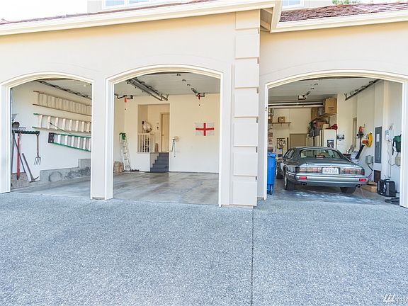 Extra big 3 car garage with deep 3rd bay on the right side. Work shop space & added storage closets.