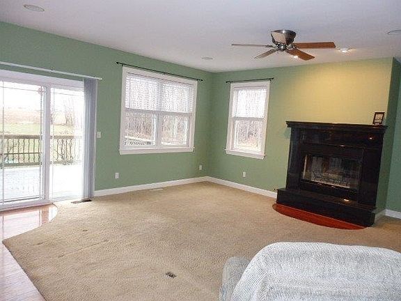 Living room, wood burning fireplace, slider to deck.
