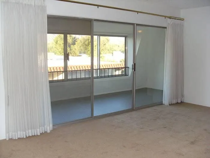Arizona room off master bedroom with fantastic 180 degree view of Catalina Mtns. (Drapes over sheers not pictured.)