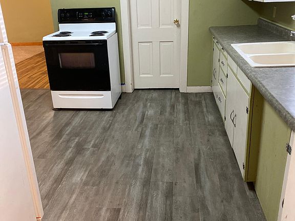 Kitchen looking south into dining area with hardwood floor