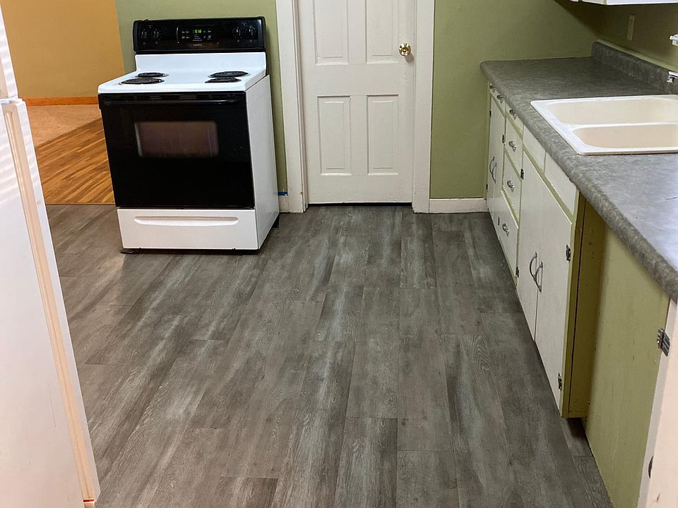 Kitchen looking south into dining area with hardwood floor