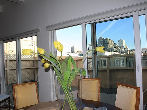 Dining area with deck and city view.