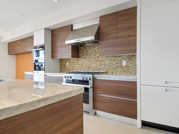 Top of the line Miele appliances, including fridge, freezer, dishwasher, range, hood, coffee maker, and steam oven. There is a full walk-in pantry with a wine fridge.