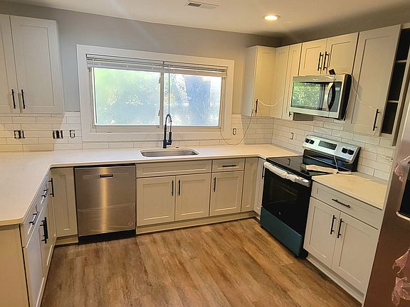 Modern kitchen with quartz countertop, soft close cabinets and plenty of storage.