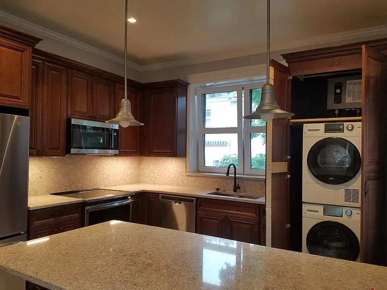Laundry in Kitchen. Pendant lights over the peninsula.