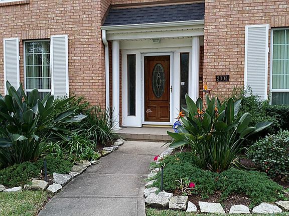 Birds of Paradise greet you walk on by to the front door. Property all the way around is nicely landscaped w/a semi-tropical vibe.