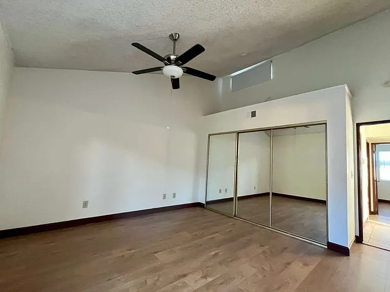 Master Bedroom, high ceiling, newly-installed wood laminate flooring and new mini-blinds, abundant closet space (2) and own en-suite bathroom on the side