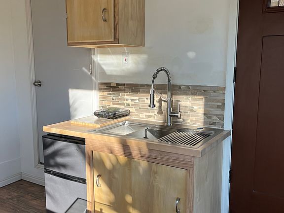 New kitchenette and cabinets with small fridge