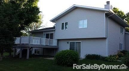 Back angle shot - new PVC Azec Deck
						:
						2 sliding patio doors, one off dining, the other off family room. Landscaping.